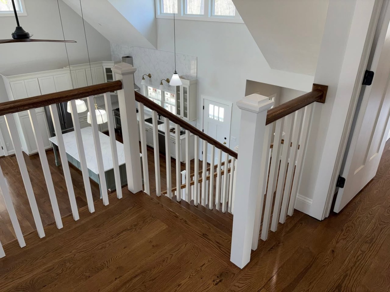 Custom staircase with stained handrail and matching hardwood treads